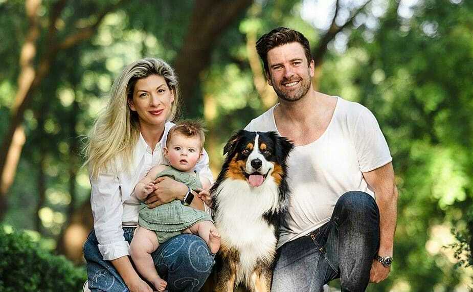 Family choosing an Australian Shepherd puppy from a breeder