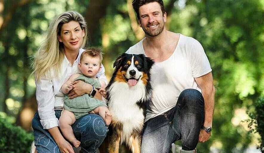 Happy family with their new Australian Shepherd puppy